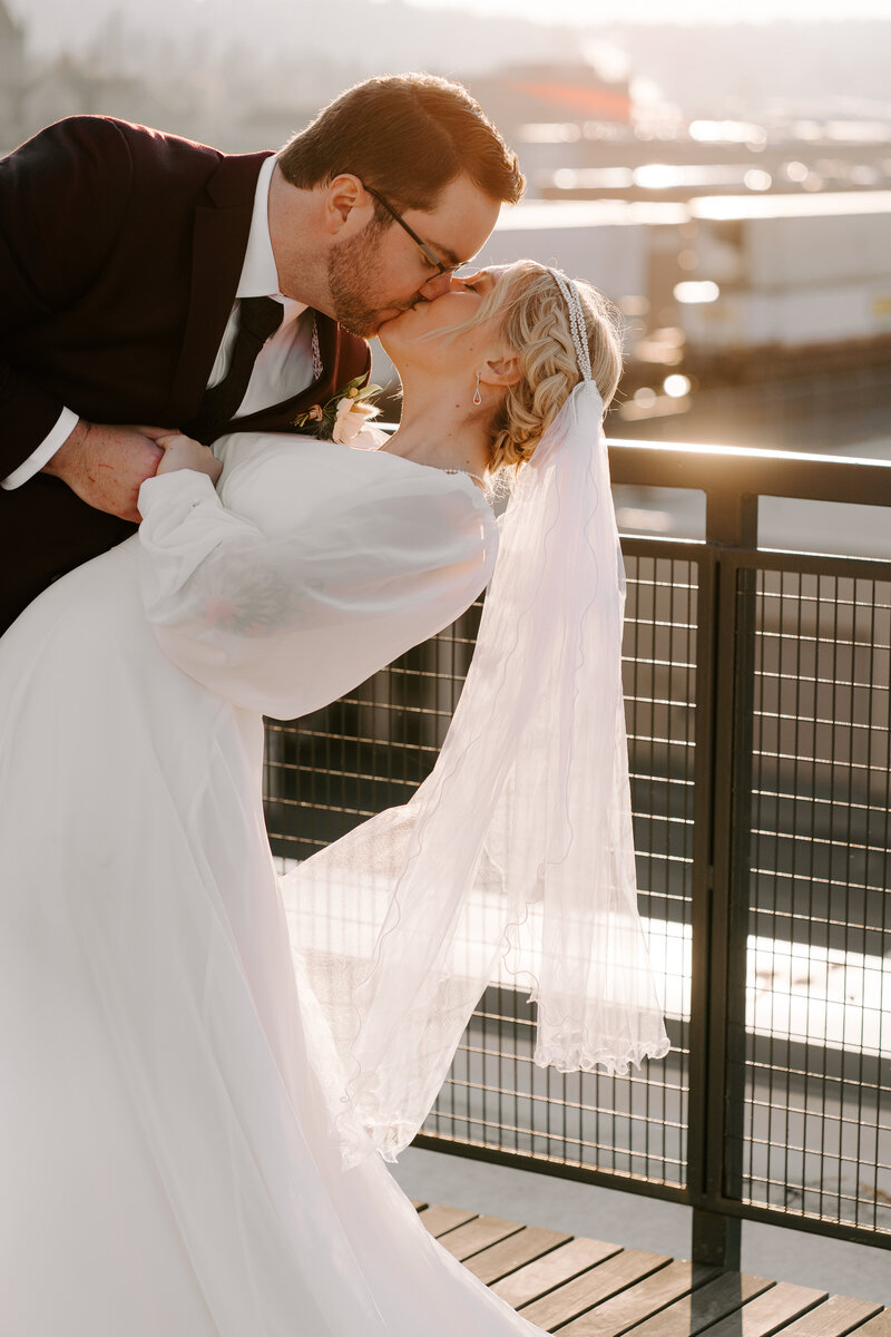A bride and groom smile at each other in their beautiful wedding venue, Chateau Rive in downtown Spokane, Washington.
