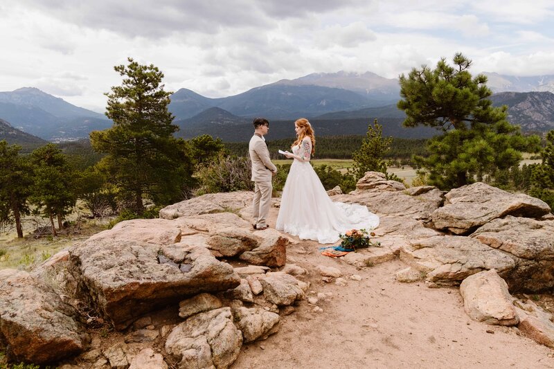 Bride and groom sharing an intimate moment during their. Rocky Mountain National Park, Colorado mountain elopement with stunning alpine views in the background with Colorado elopement photographer and videographer Alpine Vows.