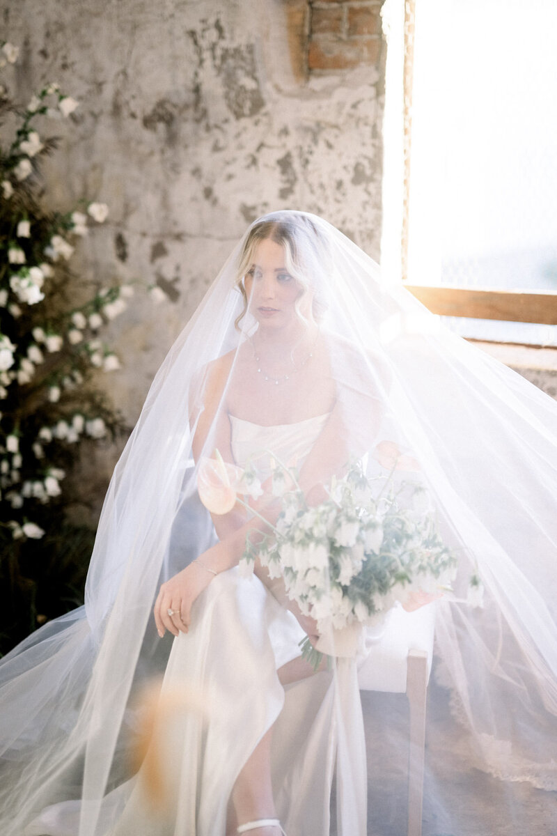 Bride in white gown and veil with bouquet - Scottsdale wedding photographer's artistic capture.