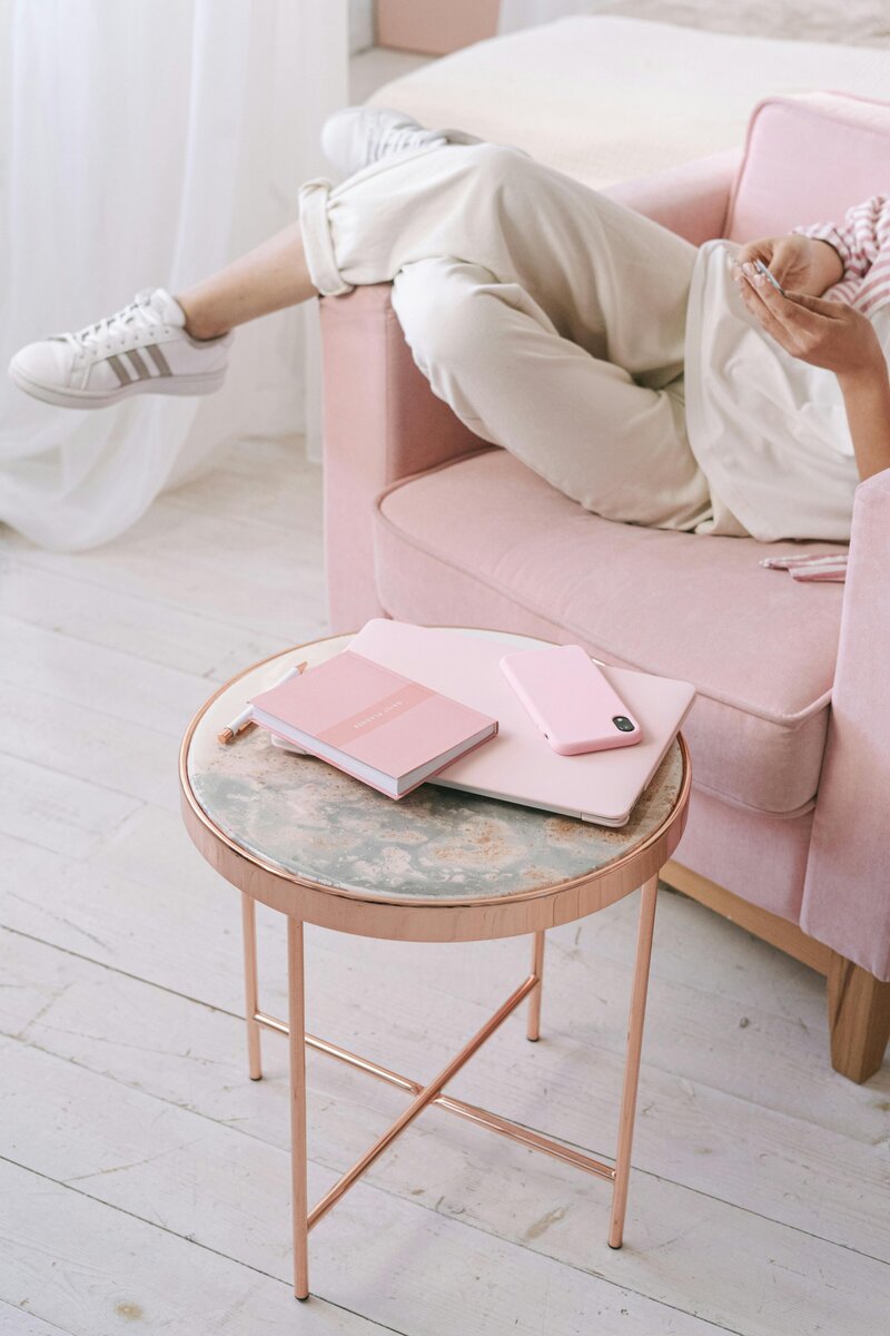 Girl in light pink chair providing pinterest management for brand and web designers