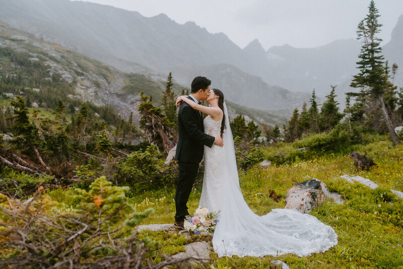 bride and groom cuddle on Loveland Pass during their Colorado elopement
