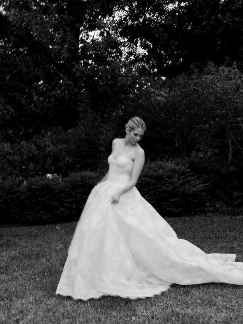 film image of a bride and groom walking away from the camera with the bride looking over her shoulder at Laguna Gloria