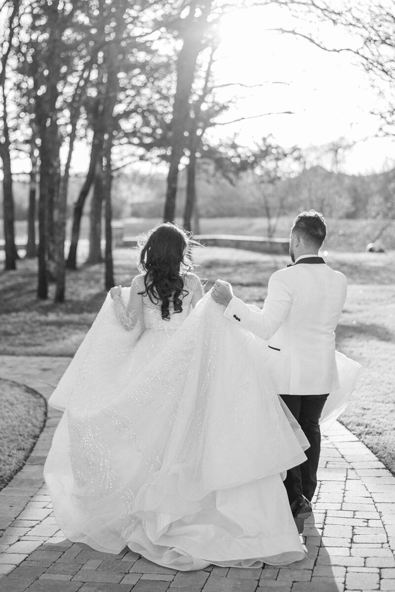 black and white of bride and groom walking