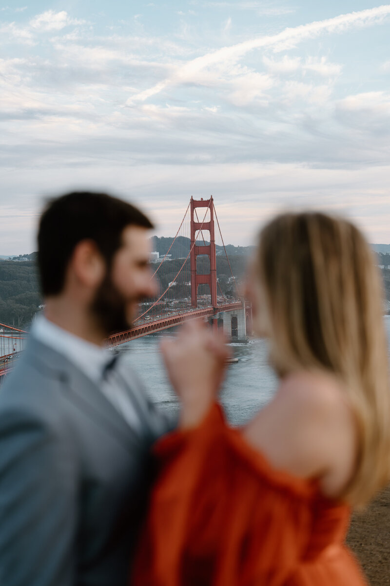 A couple in front of the Golden Gate Bridge