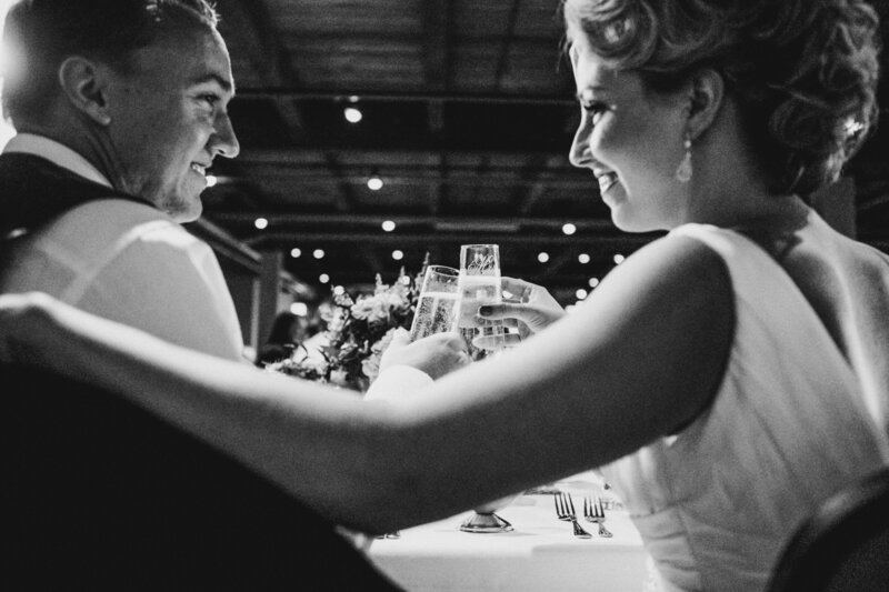 black and white image of bride and groom at reception