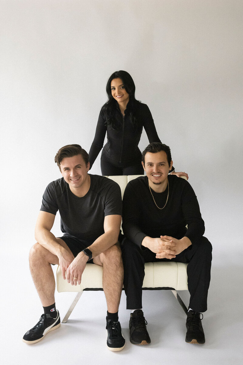 Group portrait of the Synergy EMS founders: Juan, Laura, and Mark, highlighting the people behind the brand.