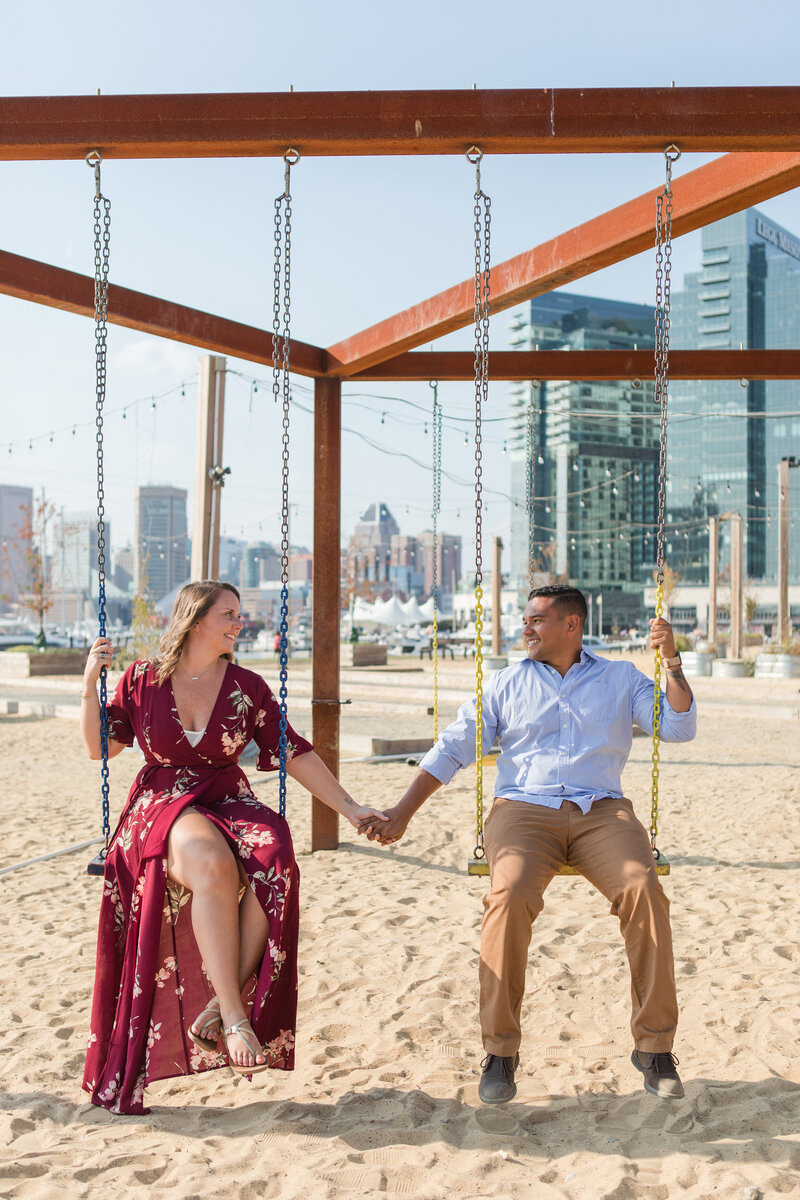 Sandlot Baltimore, Maryland engagement photos of couple on swings by Christa Rae Photography