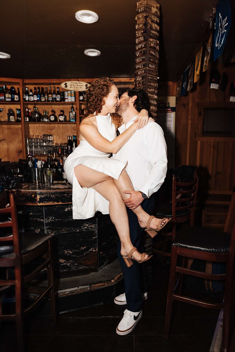 Couple Kissing in Rustic Bar Setting