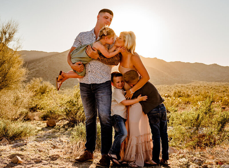 family playing for portraits in desert with Amber, phoenix photographer
