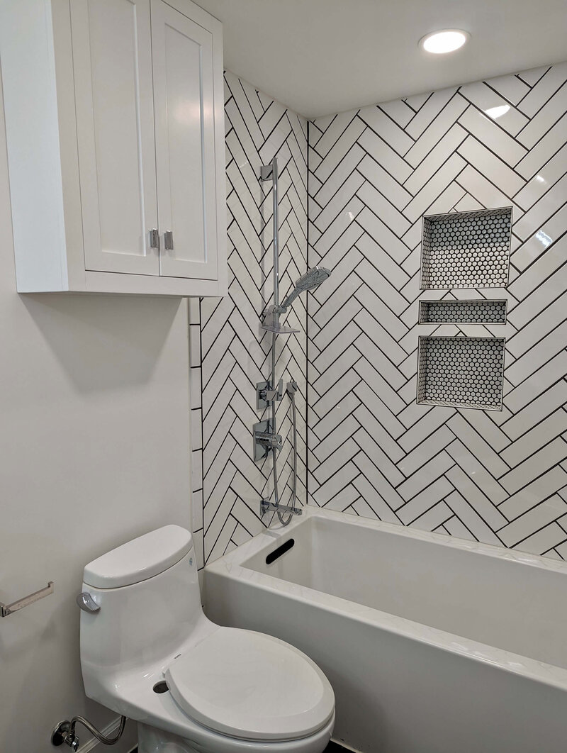Subway tile shower upgrade with custom niche and matte black fixtures