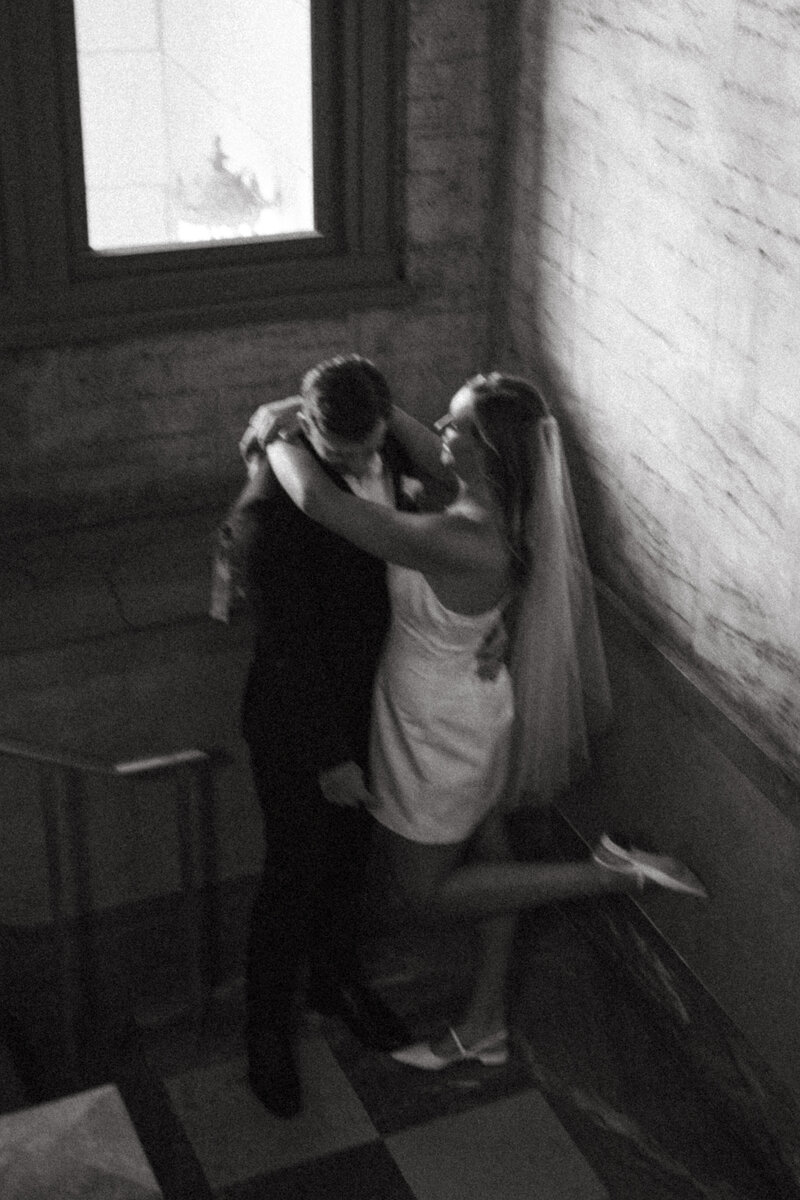 Couple embracing at the Buncombe County Courthouse after Eloping in Asheville