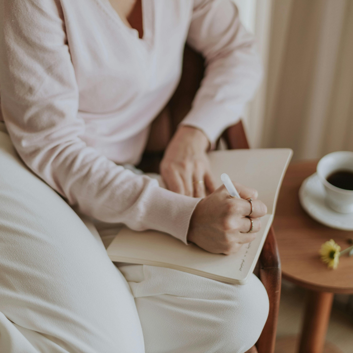 Woman newly diagnosed with MS journaling 