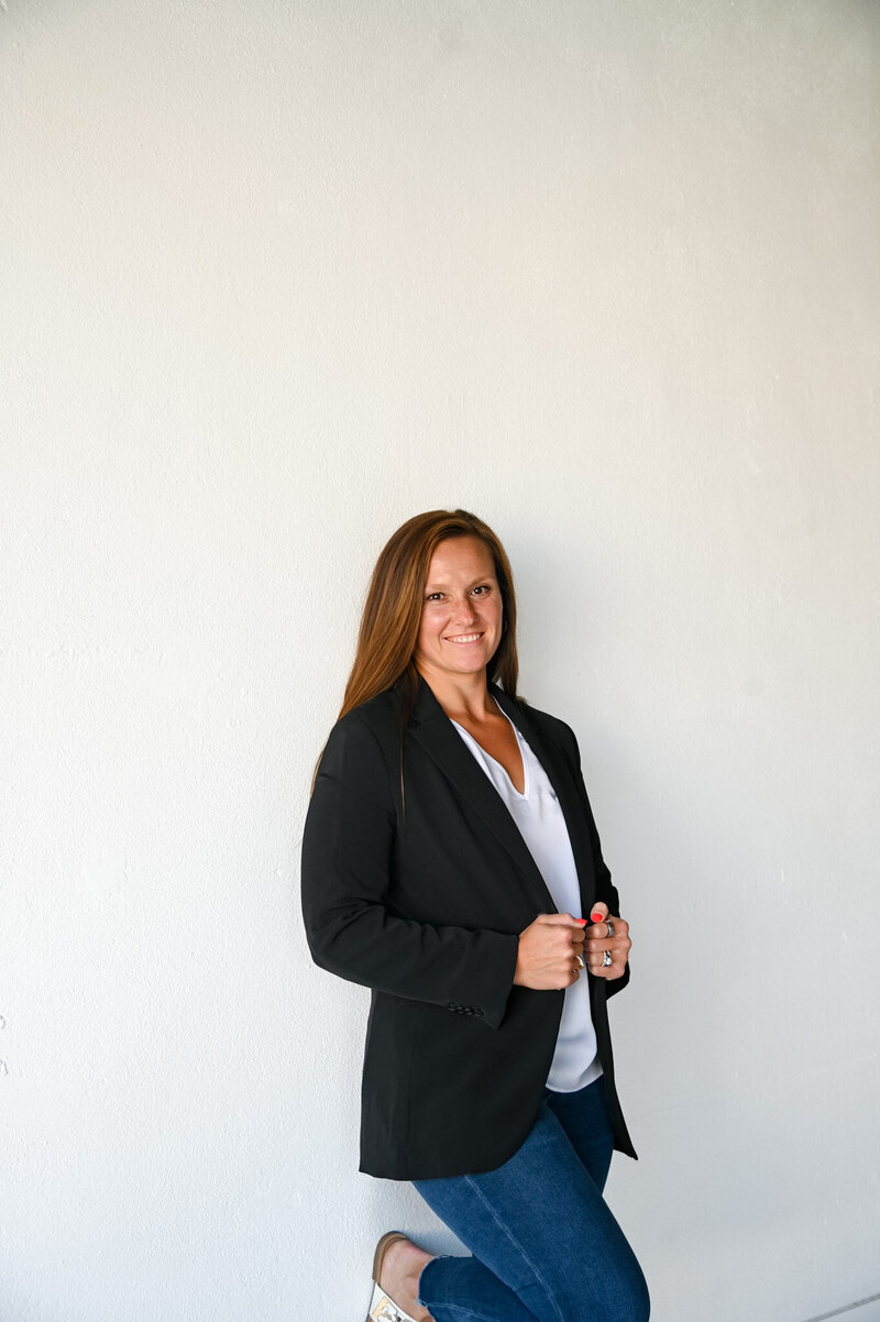 Section introducing Hannah Short of Rooted & Nourished Psychotherapy showing Hannah standing and smiling beside text about grounded care for body, mind, and self emphasizing compassion, balance, and evidence-based therapy