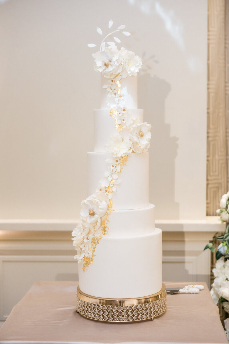Wedding cake with 5 tiers at a wedding at the four seasons Orlando by Florida wedding photographer.