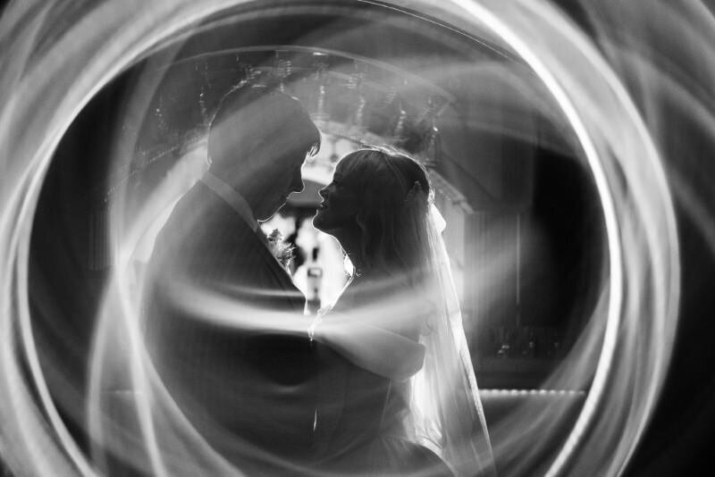 lights swirl around a bride and groom during their private last dance