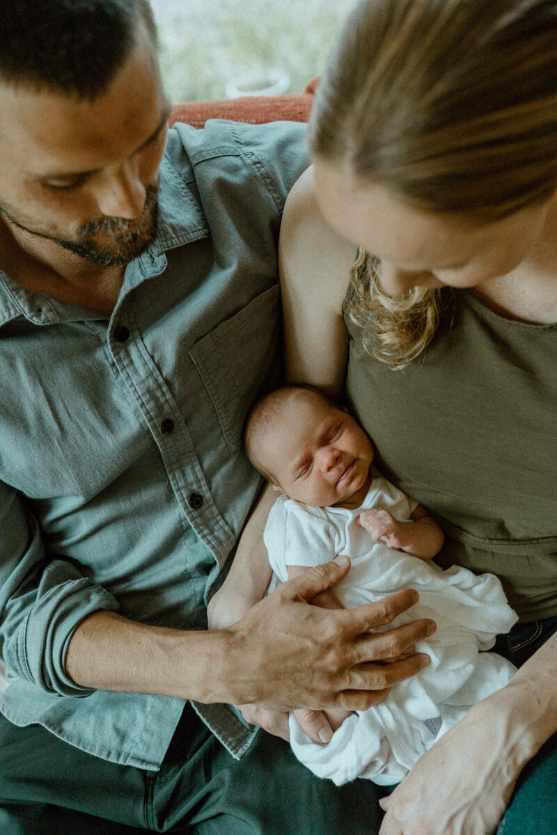 family holding newborn on couch