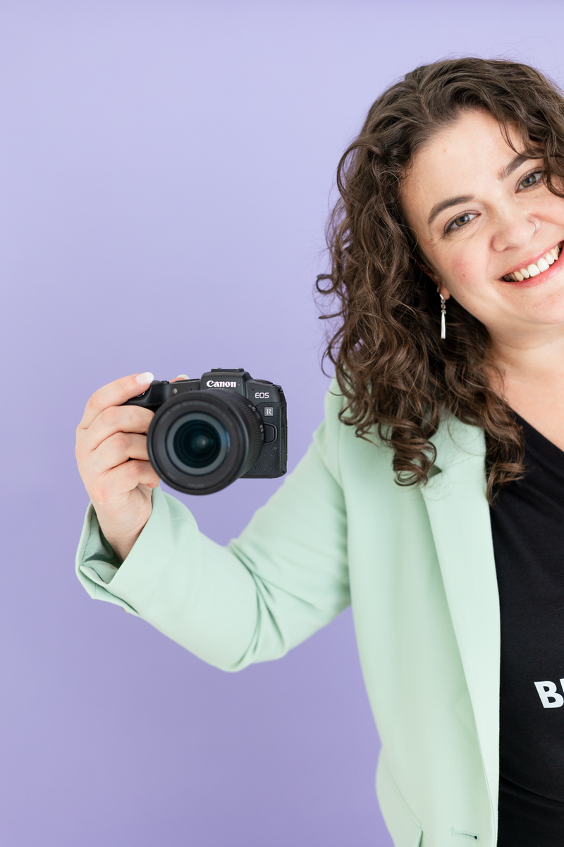 Fun headshot of woman with yellow sunglasses on brand photographer