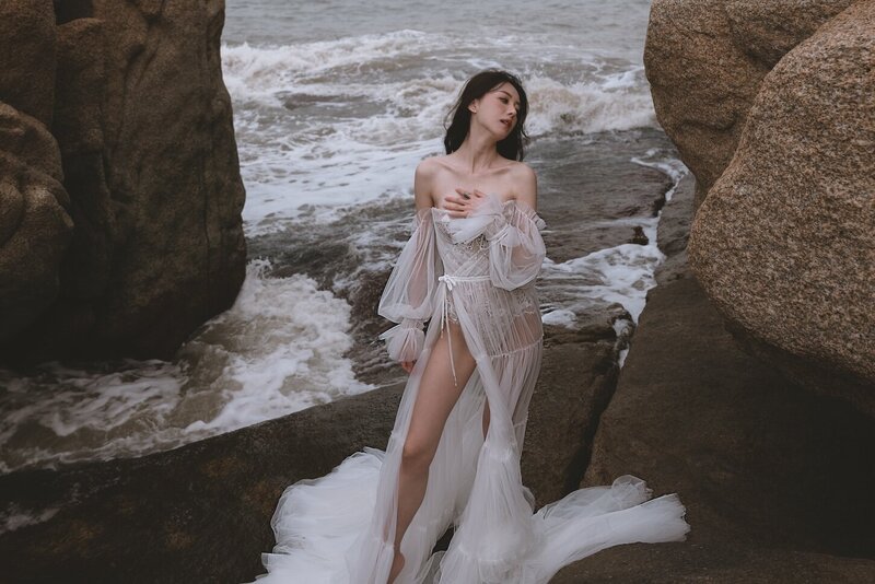 A beautiful windswept beach couture shoot amongst coastal rocks.