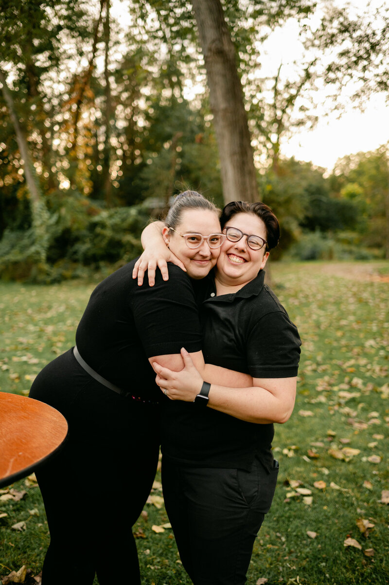Rachel and Amy smiling while working a wedding