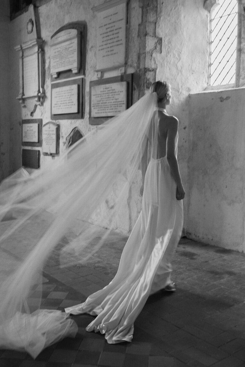 Handmade silk wedding dress with deep v back and high neck on bride