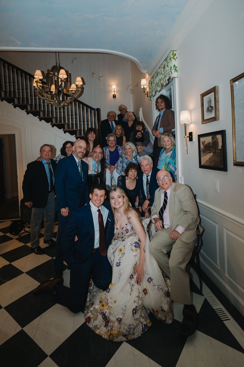 bride and groom family taking group photo