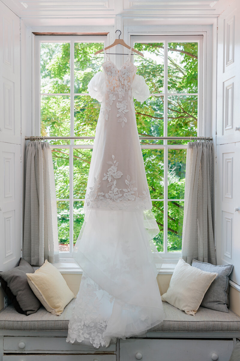 Bride and groom pose for a photo by Scranton Wedding Photographer Eric Boylan in a white gazebo at Windridge Estate in Cazenovia New York