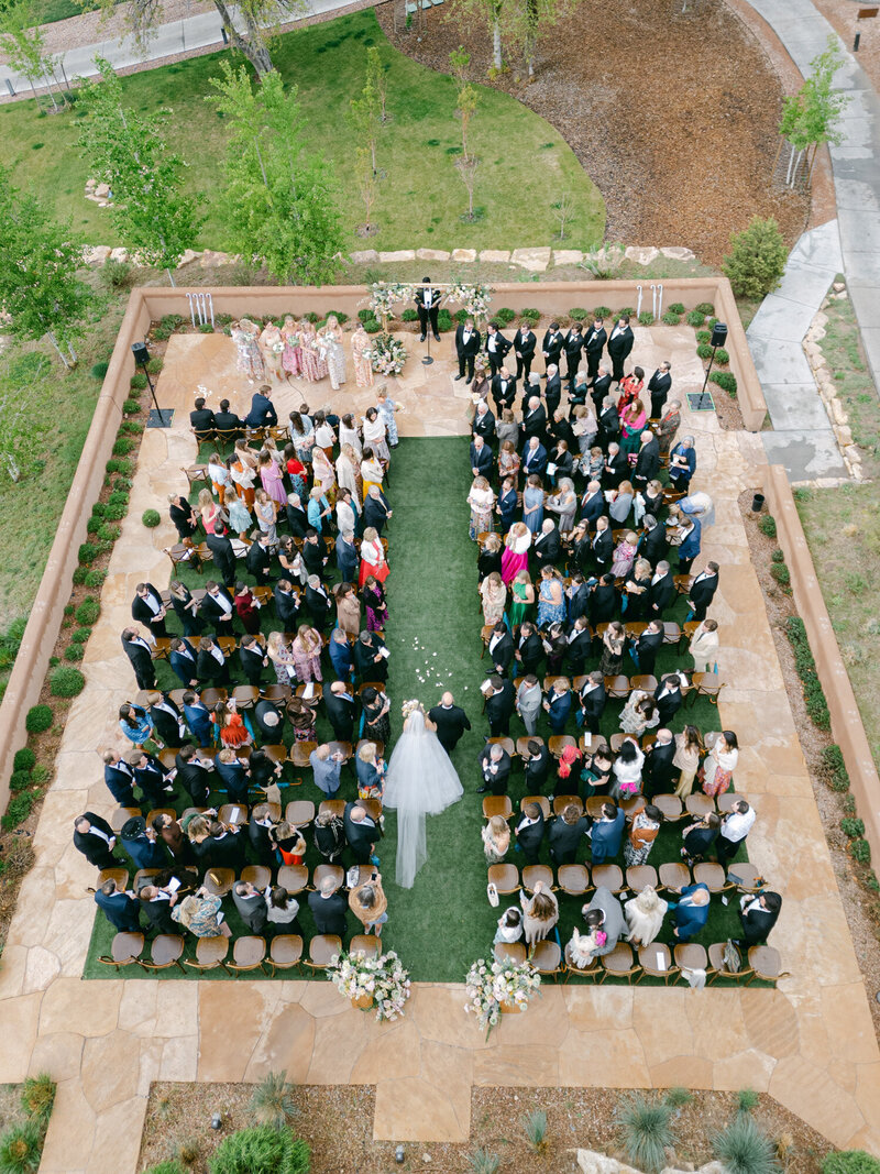 Aerial Shot of bride and dad walking down the aisle at Bishop's Lodge Resort in Santa Fe, New Mexico.