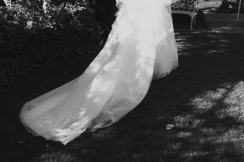 The train of a wedding dress along the ground 