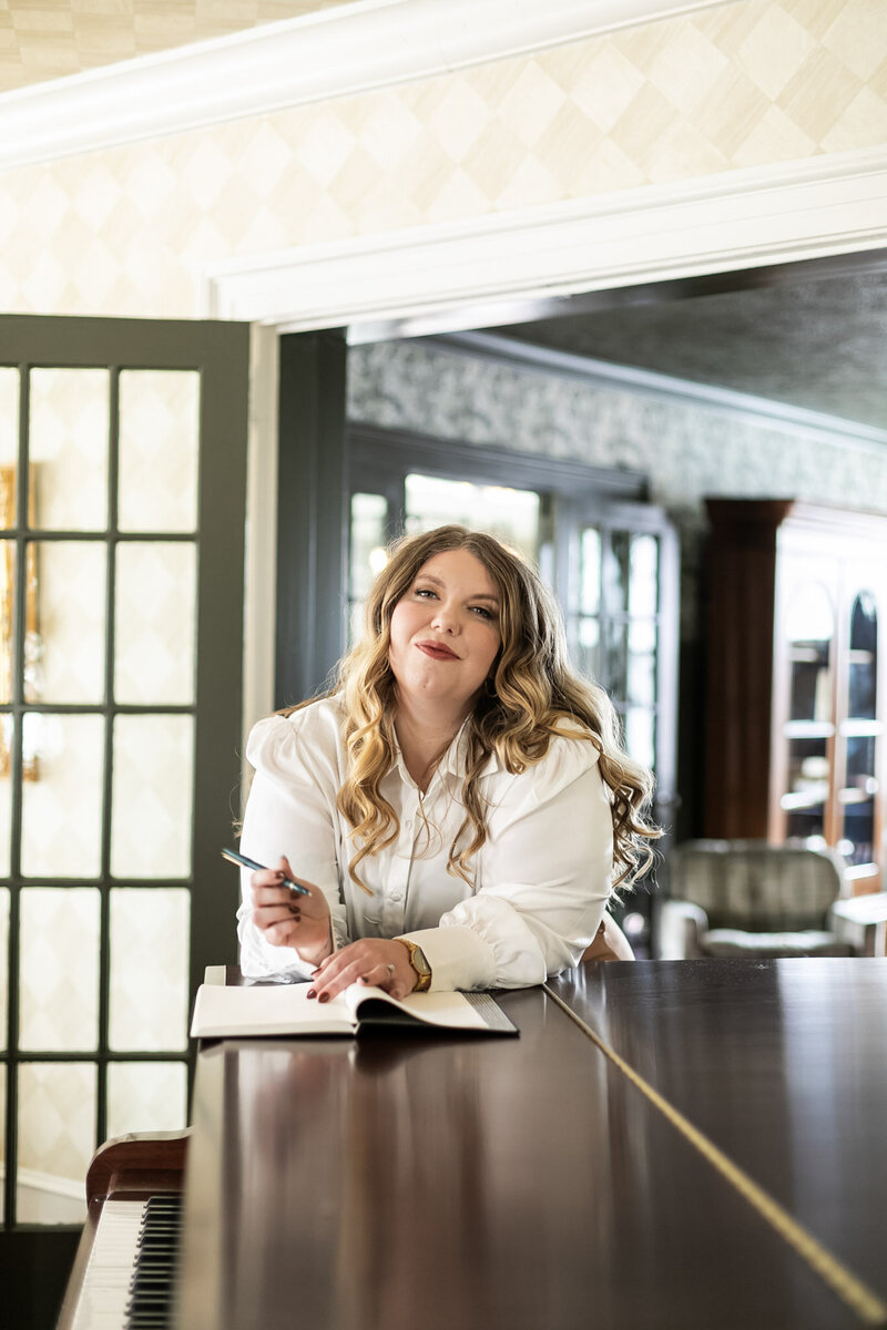 Ashleigh Henry, coach and founder, photographed in Asheville in a white button down — guiding women through the quiet unraveling of post-success life.