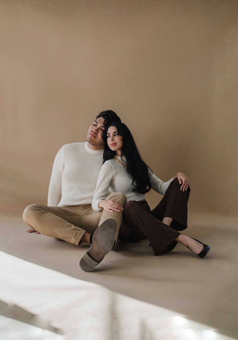 Couple sitting together posing in albuquerque photoshoot.