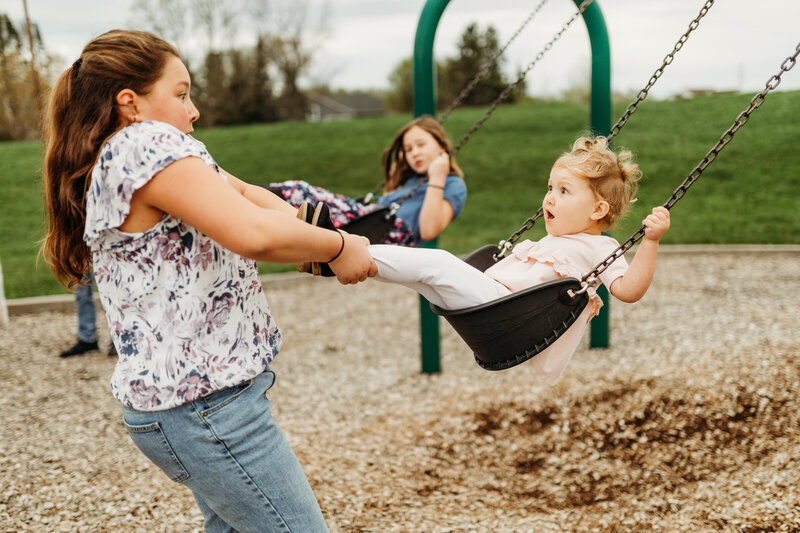 children playing on a swing set