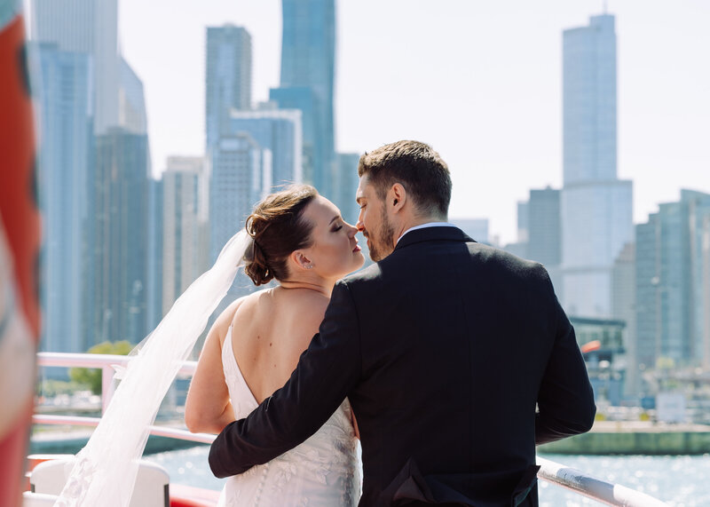 newlyweds overlooking chicago skyline after boat ceremony along lake michigan