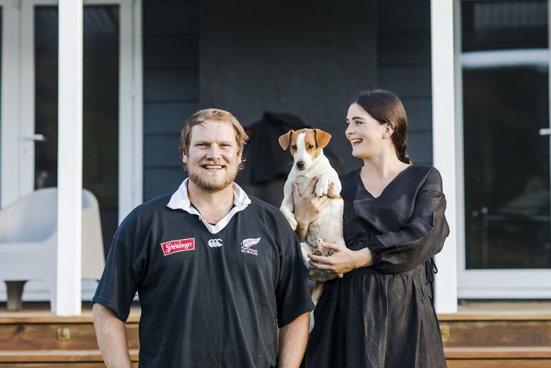 couple on doorstep with jack russell dog