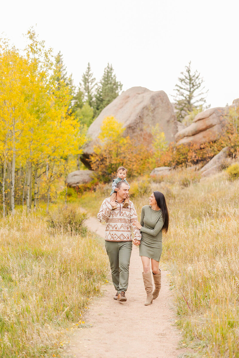 Joyful family walking together during their family session at Vedauwoo near Laramie, Wyoming.