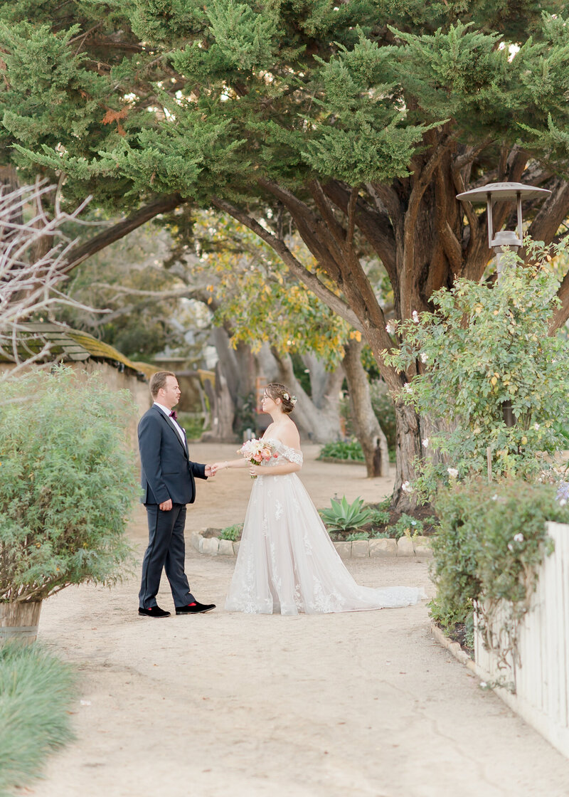 a wedding couple facing each other and laughing