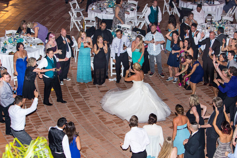 Bride and guests enjoy dancing during an outdoor destination wedding reception in Santa Barbara, California.