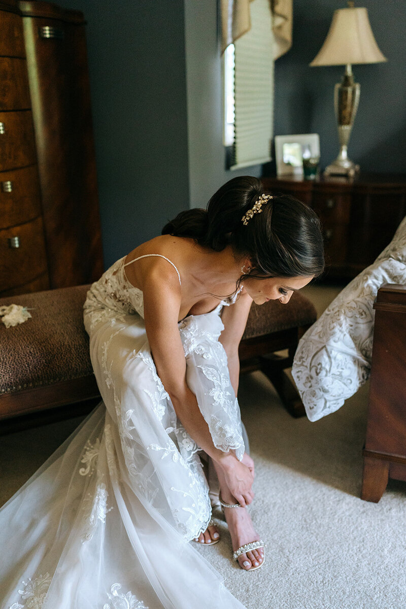 bride adjusting shoe