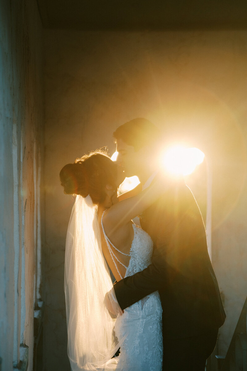 bride and groom kissing at sunset at villa antonia austin wedding venue