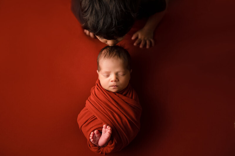 Baby Boy and Brother with Rust Backdrop and Wrap in Decatur, TX
