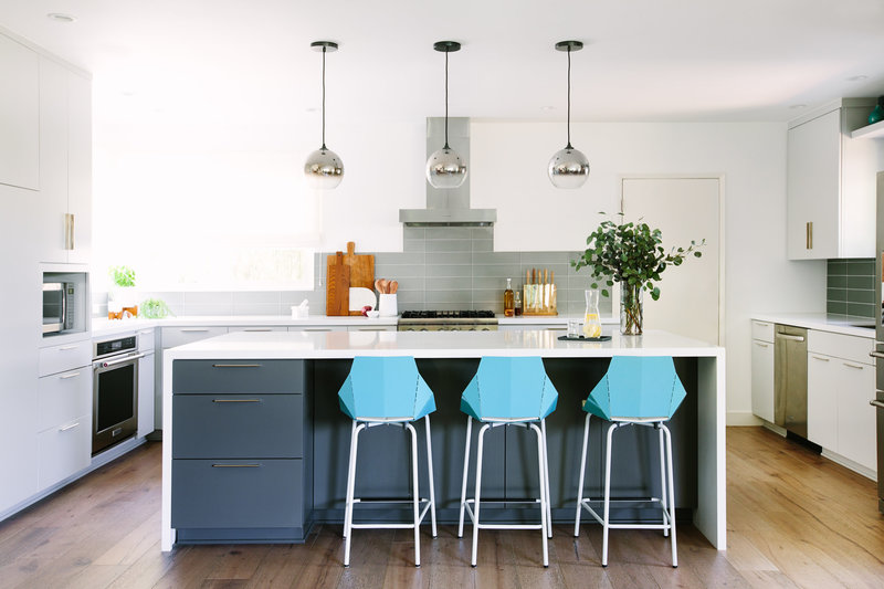 Grey and white modern kitchen with blue Blu Dot counter bar stools