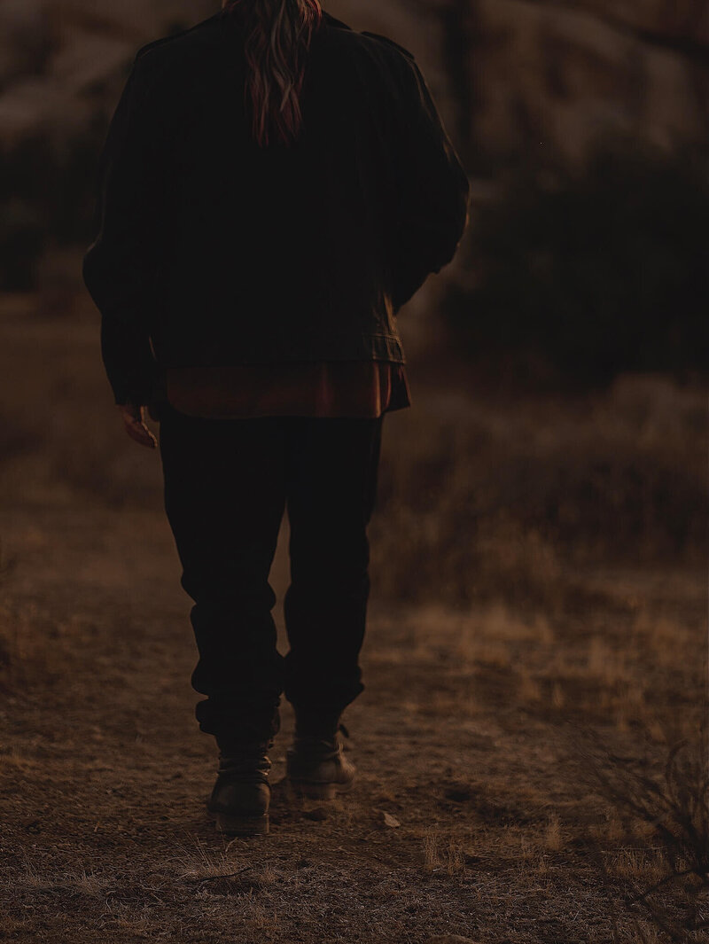 Keith walking outside with back facing