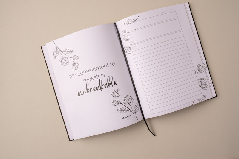 goals journal for moms black linen with gold stamping and gold pages open to the goal setting pages