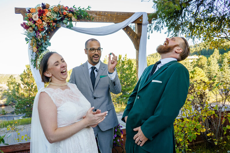 Nerdy geeky wedding with references to DND, Dungeons and Dragons and pulling out dice during the ceremony. Happy, joyous, laughing couple.