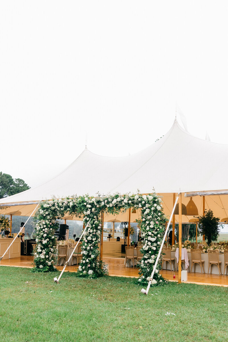 A beautifully designed luxury tent wedding at Spring Island, South Carolina, featuring lush floral arrangements and an elegant outdoor reception. This sophisticated celebration blends nature with refined elegance for a timeless wedding experience. Amia Marcell wedding photographer South Carolina.