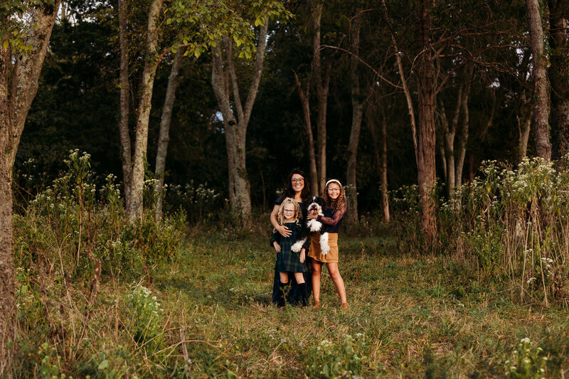Family posing for photos with franklin, Tennessee photographer 