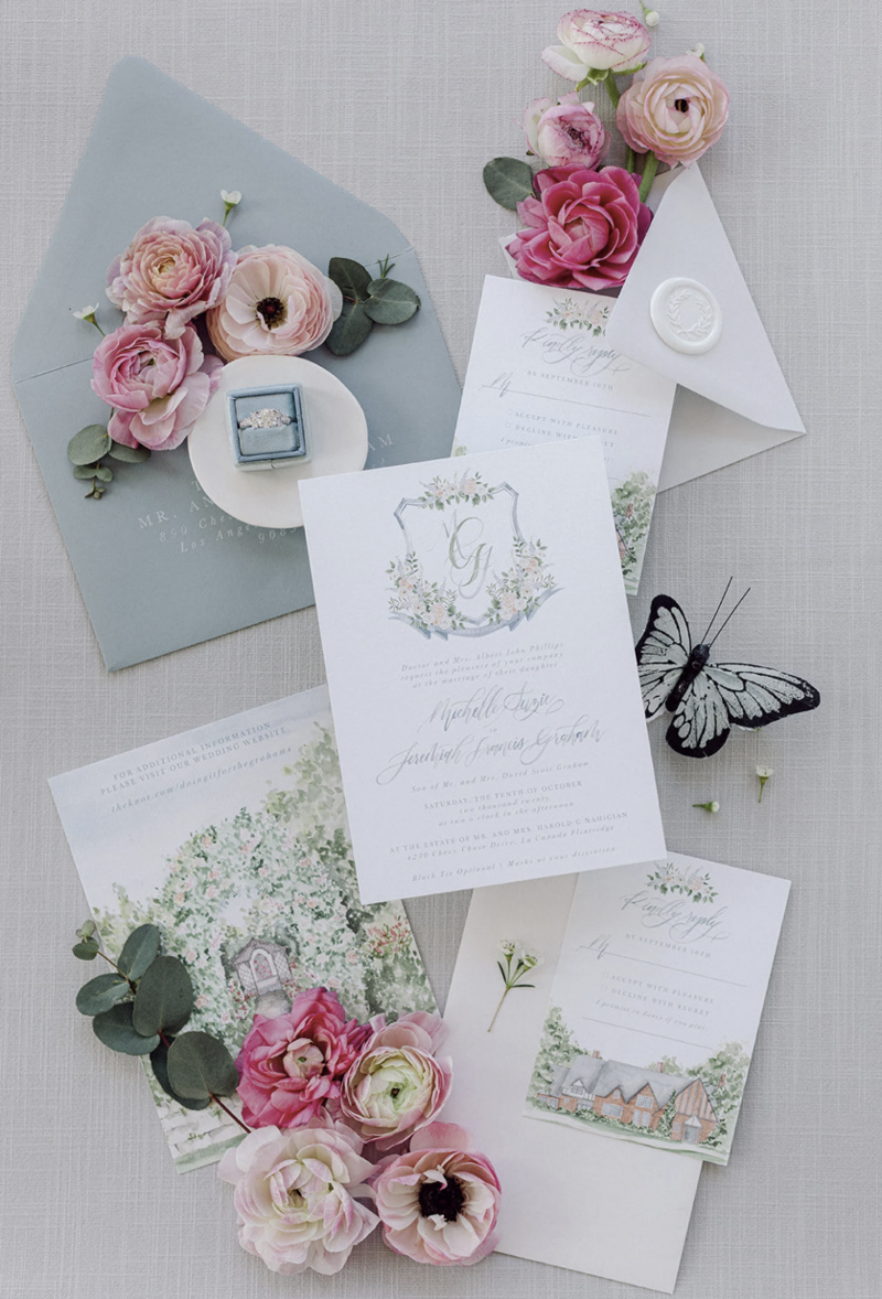 Gray linen styling mat with modern wedding invitations and minimal florals