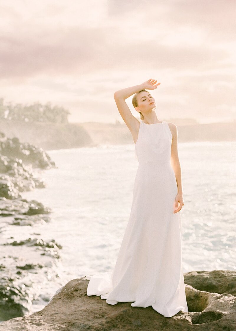 Bride at Maui North Shore Cliffs for sunset golden portraits