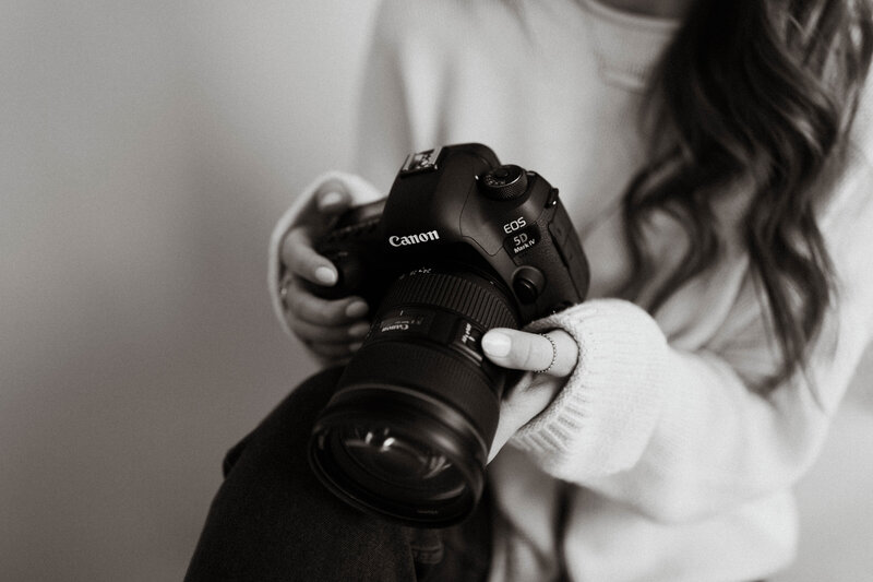 Close up of photographer's hands holding camera