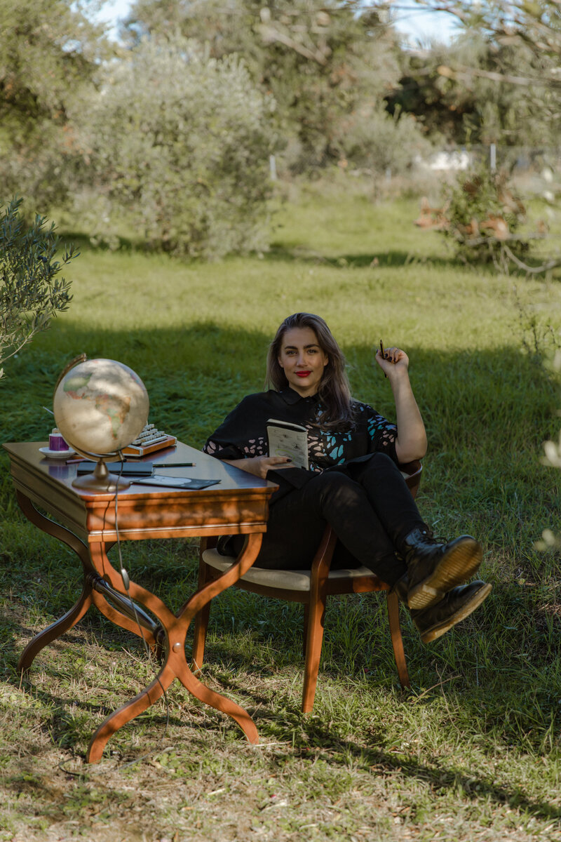 Marta Custic, brand designer, sitting outside, holding sketch pad