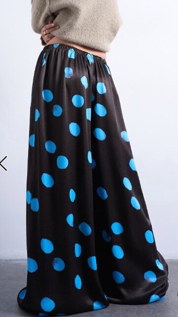 Topshop satin wide-leg pants in brown with oversized blue polka dots, styled with a neutral sweater for a trendy fall look.